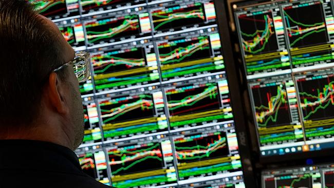 A trader works at his desk on the floor of the New York Stock Exchange (NYSE) during the first session of the new year on January 2, 2025, in New York City. (Photo by TIMOTHY A. CLARY / AFP)