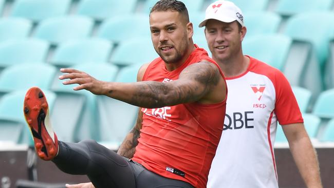 Geelong champ Steve Johnson keeps a close eye on Lance Franklin at pre-season training.