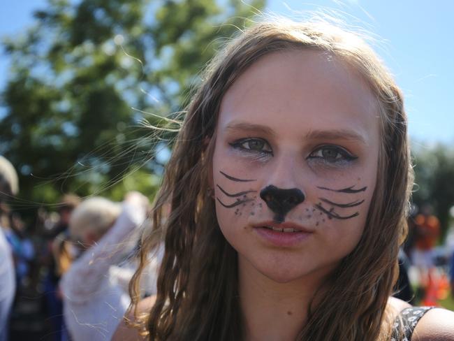 All ages untied ... A young protester against the poaching of Cecil the lion stands outside Dr Palmer’s dental clinic. According to reports, the 13-year-old lion was lured out of a national park in Zimbabwe and killed by Dr. Palmer, who had paid at least $50,000 for the hunt. Picture: Getty Images/AFP