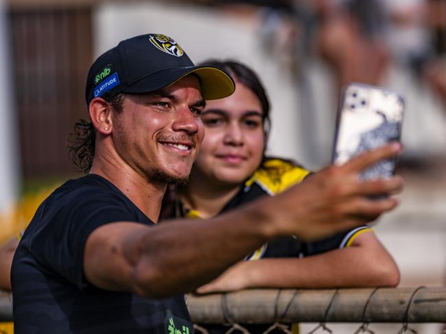 Home town hero Daniel Rioli snapping a selfie with a fan after Richmond's open training run. Picture: Patch Clapp (AFLNT Media).