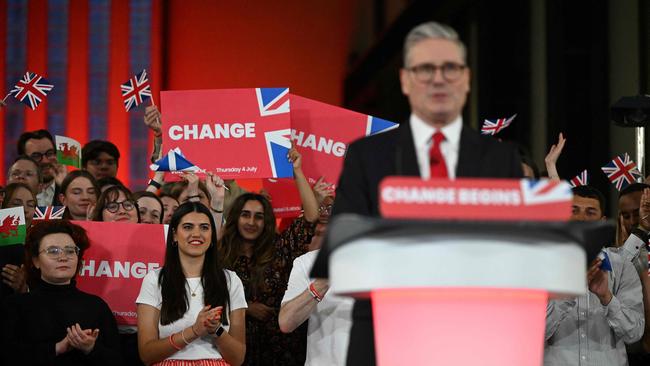 Supporters listen as Keir Starmer delivers a speech during a victory rally at the Tate Modern, London.