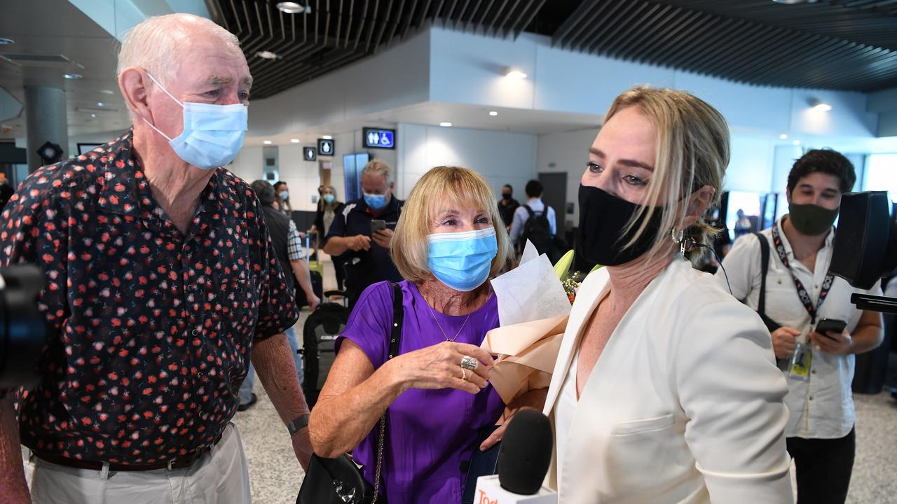 Mike Ahern (left) with his wife Andrea (middle) and their daughter Christine Ahern during a surprise reunion following the easing of Queensland's border restrictions. Picture: Dan Peled/ Getty