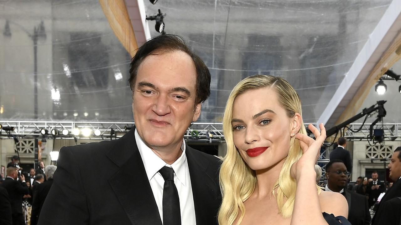 Tarantino – seen here with Aussie actress Margot Robbie – says he’s never bought his mother a house or a car. Picture: Getty Images/AFP