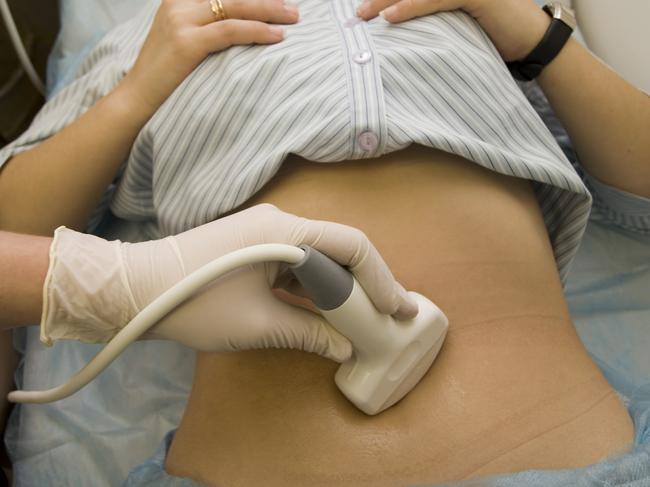 Scanning of a stomach of the woman. Scanning of a stomach of the pregnant woman in clinic.