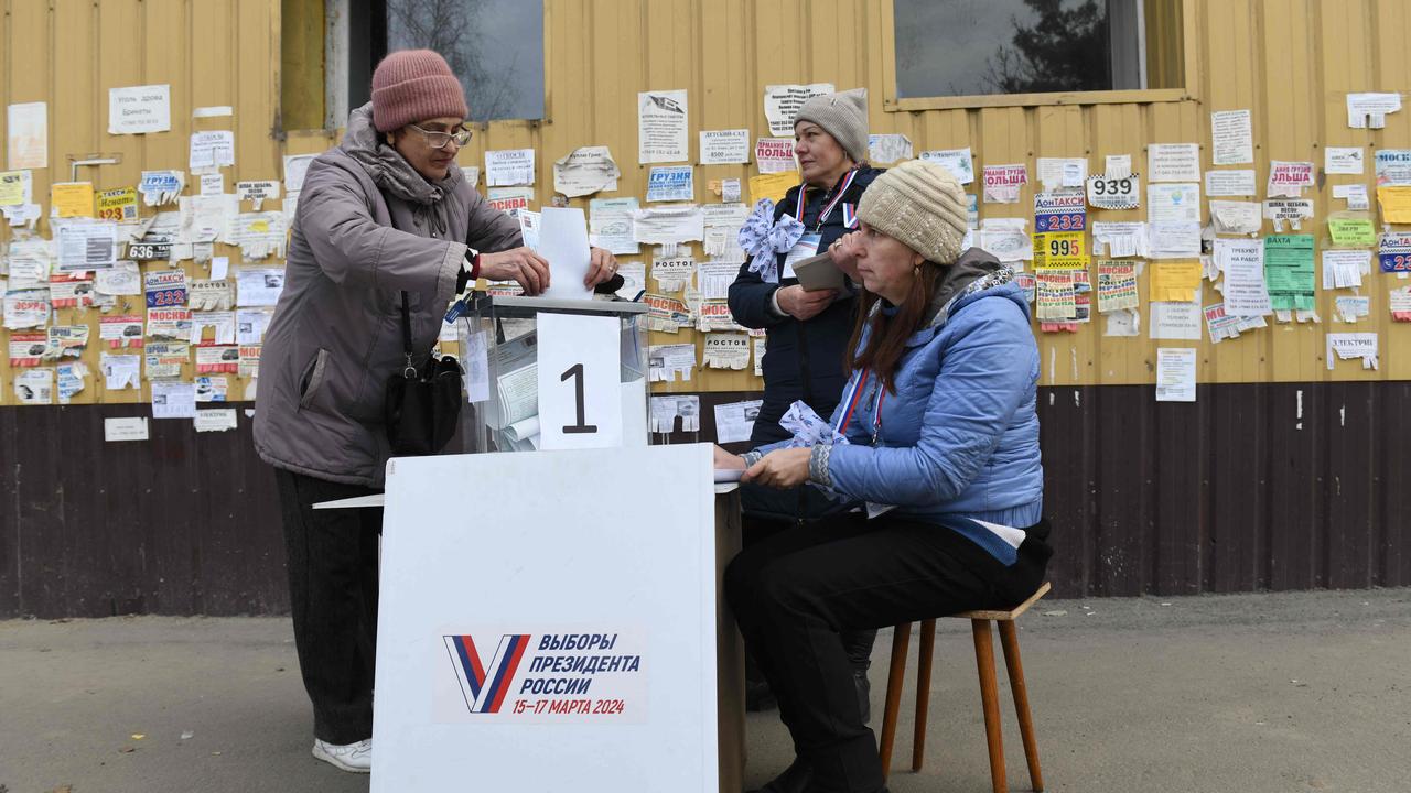 A woman casts her ballot at a mobile polling station during early voting in Russia's presidential election in Mariupol, Russian-controlled Ukraine. Picture: AFP
