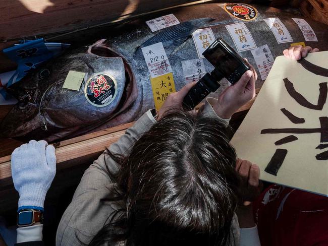 TOPSHOT - A crate holding a bluefin tuna - which was purchased earlier in the day for over 270,000 USD at the first tuna auction of the New Year - is unloaded outside the Sushi Ginza Onodera main store in Omotesando in Tokyo on January 5, 2023. - Michelin-starred sushi restaurant Onodera Group and Japanese wholesaler Yamayuki forked out 273,000 USD for the 212-kilo bluefin tuna in the auction at Tokyo's Toyosu fish market early morning on January 5. (Photo by Richard A. Brooks / AFP)