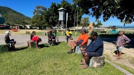 Members of the Palm Island night patrol group William Blackman, Fred Bulsey and Raoul Miller (front to back) and Uncle Merv Prior (elder) talking to six young boys who should have been at school. Picture: Supplied