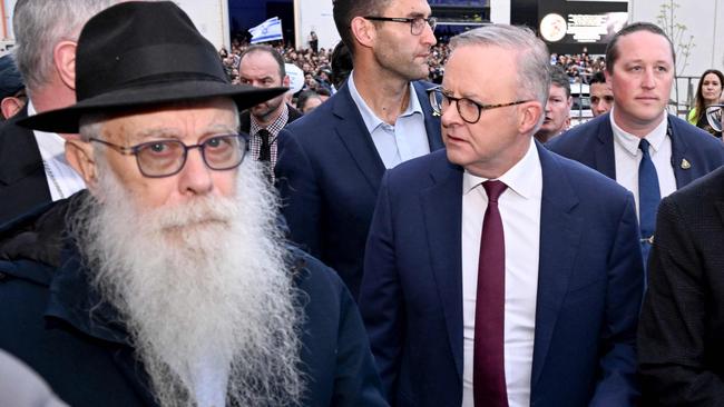 Australia's Prime Minister Anthony Albanese (C) walks with members of the Melbourne Jewish community during a vigil held on the first anniversary of the Israel-Hamas conflict, in Melbourne on October 7, 2024. (Photo by William WEST / AFP)