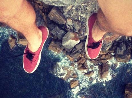 One of the last photos 25 year old Gareth Jones shared on his Instagram account, showing his legs dangling over North Head, where he fell to his death on Sunday. Picture: Supplied