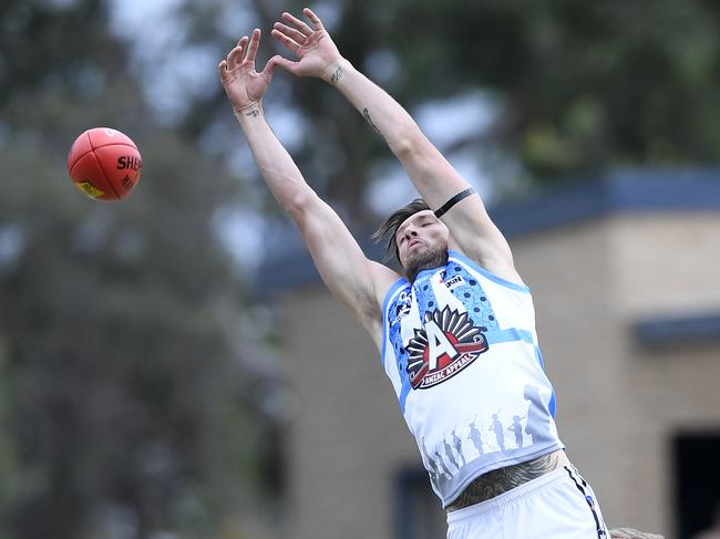 Michael Bussey reaches high for Edi-Asp. Picture: Andy Brownbill