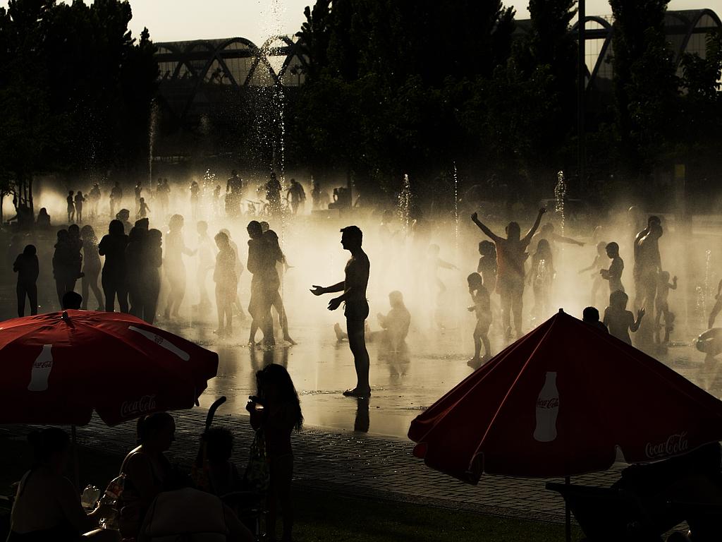 People cool down in a fountain beside Manzanares river in Madrid, Spain, Tuesday, June 30, 2015. Weather stations across Spain are warning people to take extra precautions as a heat wave engulfs much of the country, increasing the risk of wildfires. Picture: AAP