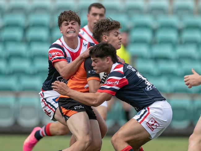 Taj Handsaker is met by the Roosters defence. Picture: Julian Andrews