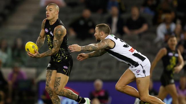 Tigers star Dustin Martin gets a handball away in front of Jeremy Howe. Picture: Michael Willson/AFL Photos via Getty Images