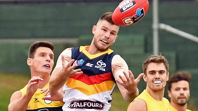 Bryce Gibbs leads Eagle attempts a grab in the SANFL clash at Woodville Oval. Picture: TOM HUNTLEY