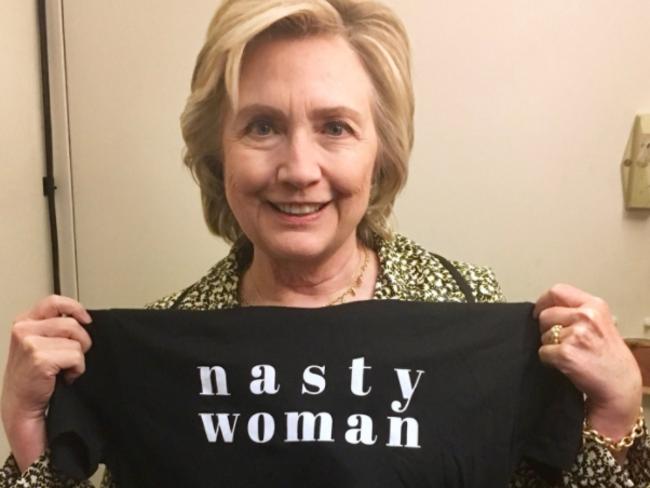 Hillary Clinton hols up a T-shirt displaying the “nasty woman” phrase that was used as a campaign tool toward the of the 2016 presidential election. The phrase was first used by Donald Trump to describe his opponent. Picture: Twitter/@HillaryClinton