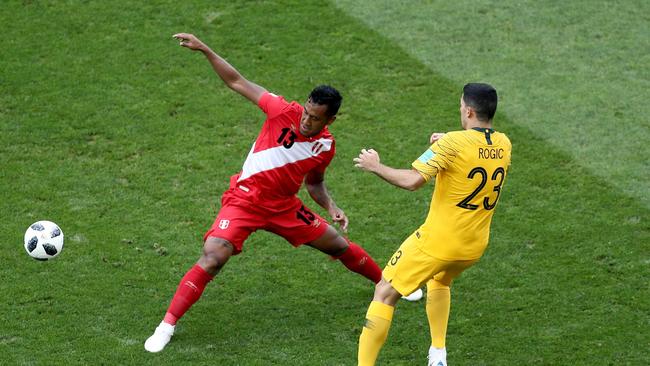 Socceroos star Tom Rogic (right) is challenged by Renato Tapia of Peru. Photo: Getty Images