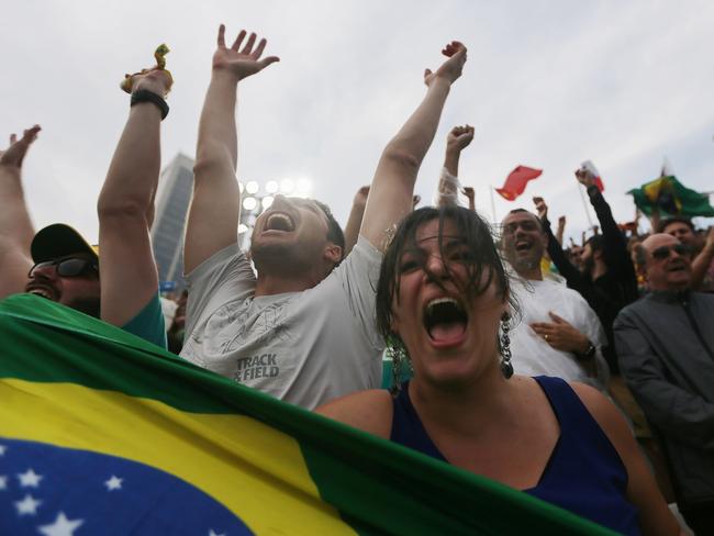 Brazilian fans cheer as their men's beach volleyball team defeats the United States