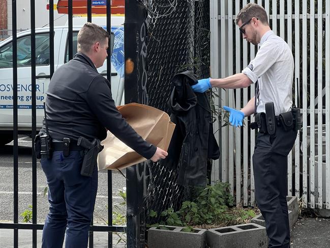 Detectives bag a jacket used to help stem the bleeding of the stabbing victim. Picture: Fergus Ellis