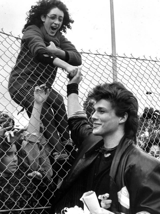 A-Ha lead singer Morten Harket shakes the hand of a fan at Tullamarine Airport in Melbourne, 1986.