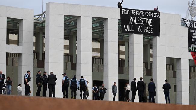 Pro-Palestine protesters take to the roof of Parliament House to unfurl a banner. Picture: NewsWire/ Martin Ollman