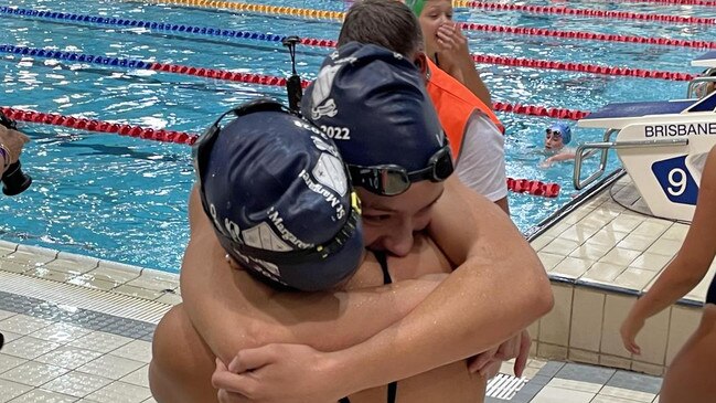 At the QGSSSA championship, Junior Dolphin Sophie Martin gets a hug off her sister Isabella, herself a Queensland team selection this season.