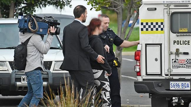 A woman is arrested for spitting at a TV camera operator outside Elizabeth Magistrates Court. Picture: Tom Huntley