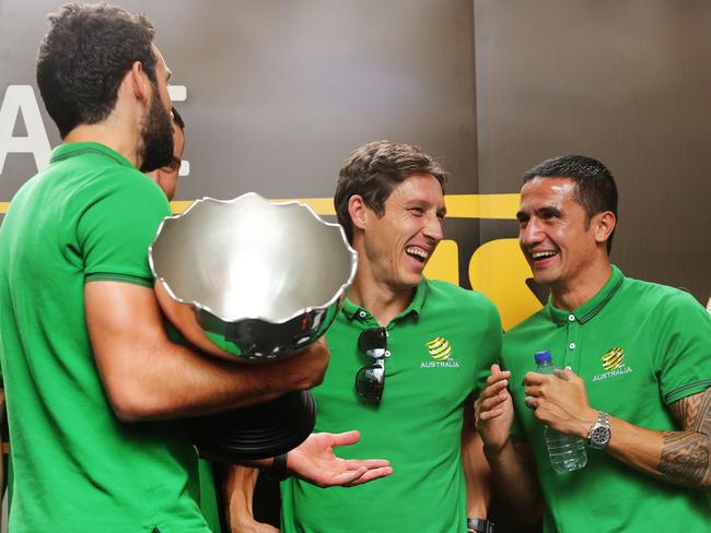 Mark Milligan (centre) celebrating the Asian Cup win with (left) Mile Jedinak and (right) Tim Cahill.