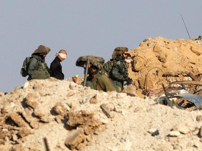 Israeli soldiers detain blindfolded Palestinian men in a military truck. Picture: AFP