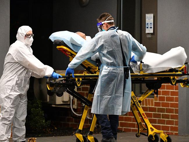 Healthcare workers transport a person into a patient transport vehicle at the Arcare Aged Care facility in Melbourne, Wednesday, June 2, 2021. (AAP Image/James Ross) NO ARCHIVING