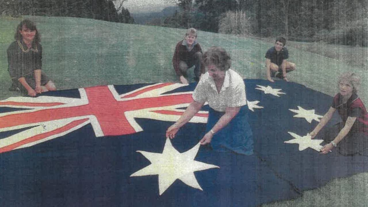 NATIONAL KNIT: Knitting expert Shirleigh Greenwood (centre), with students Kirstine Morse, Stephen Chapman, Anthony Morse and Elizabeth Windley, with a 3000-stitch Australian flag in 1986, which was gifted to the then-Toowoomba City Council.