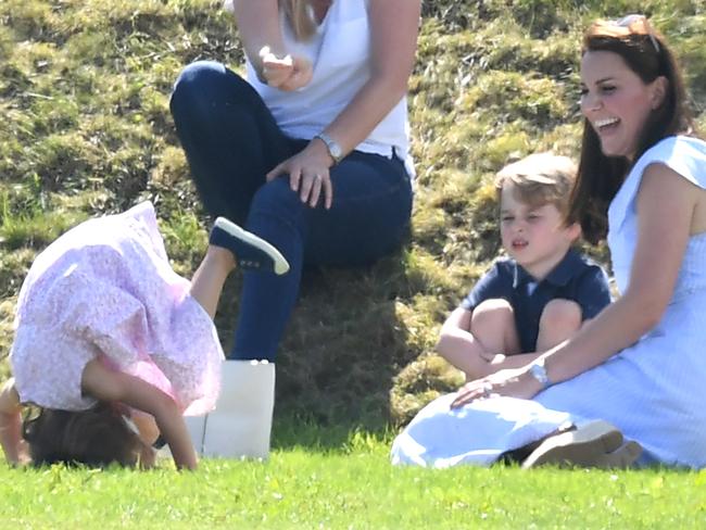 Princess Charlotte does somersaults as Prince George and Catherine, Duchess of Cambridge, watch on. Picture: James Whatling/Mega