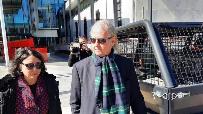 Roger Uren leaves the ACT Magistrates Court with his lawyer, Noor Blumer, after pleading guilty to breaching secrecy laws. Picture: Craig Dunlop