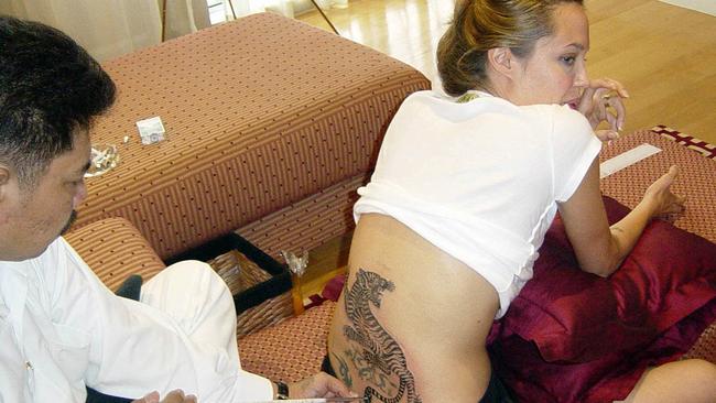 Jolie had her back tattoo done in Thailand in 2004. Picture: AFP.