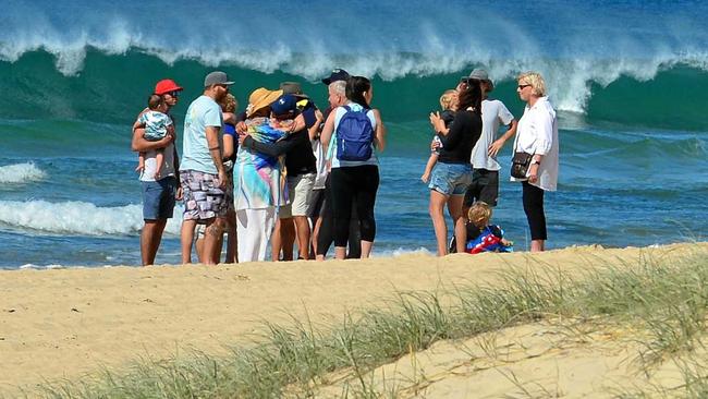 TRAGEDY: The search for lost fisherman Luke Howard was called off after 45 hours after his body was recovered on the eastern side of Old Woman Island. Family and friends grieve on Mudjimba Beach. Picture: John McCutcheon