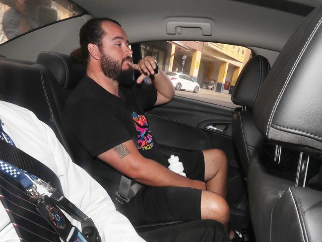 Former Kimberley College principal Paul Thomson's son-in-law Kevin Ferguson being driven into the Brisbane watch house by police. Photographer: Liam Kidston.