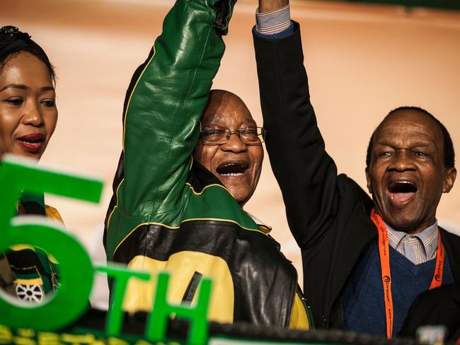 South Africa's President Jacob Zuma reacts during celebrations for his 75th birthday on April 12, 2017 in Kliptown, Soweto.  Rival South African opposition parties joined forces on April 12 when tens of thousands of demonstrators marched through the capital Pretoria calling for President Jacob Zuma to resign, AS Zuma's recent sacking of respected finance minister Pravin Gordhan has fanned years of public anger over government corruption scandals, record unemployment and slowing economic growth. / AFP PHOTO / John WESSELS