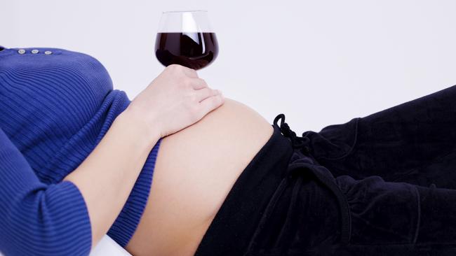 Pregnant woman with a glass of wine. Picture: Thinkstock