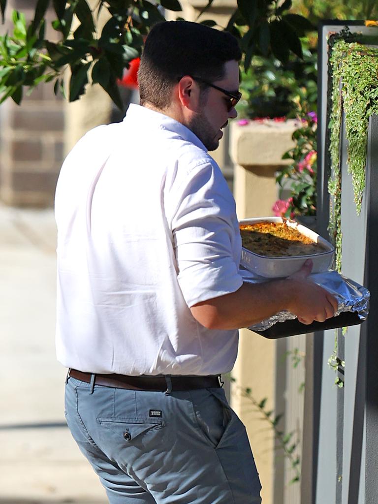 Mr Lehrmann brings plates of food to a friend’s house. Picture: KHAPGG