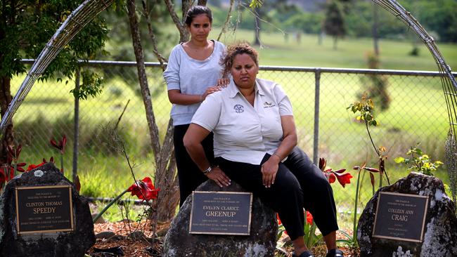 Lytiah Stadhams (left) and Michelle Stadhams, the sister and aunt of Evelyn Greenup, at the memorial stones for the three children in Bowraville.