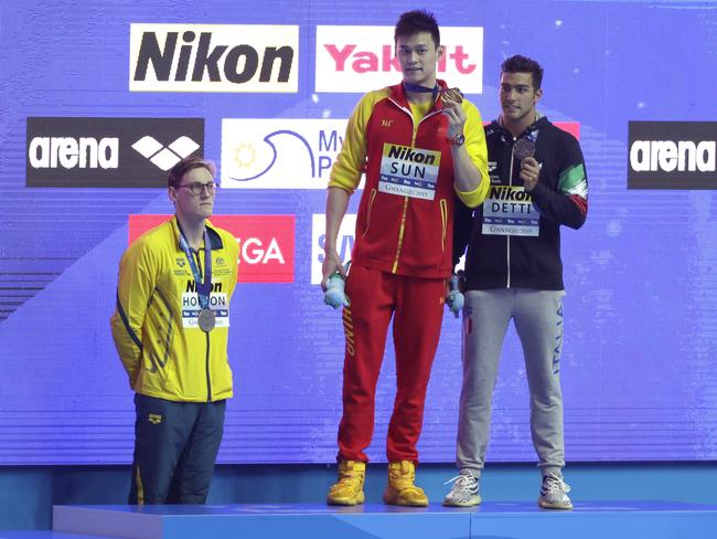 China's Sun Yang, centre, holds up his gold medal as silver medallist Australia's Mack Horton, left, stands away from the podium with bronze medallist Italy's Gabriele Detti at right, after the men's 400m freestyle final at the World Swimming Championships in Gwangju, South Korea. Picture: AP