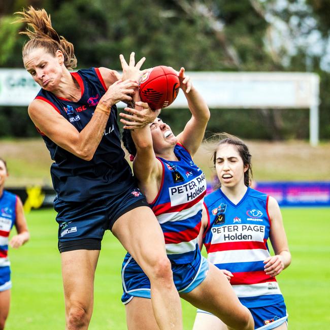 Norwood's Jo Hill in a fiercely contested mark with Central District's Abbie Sheer. Picture: Peter Argent