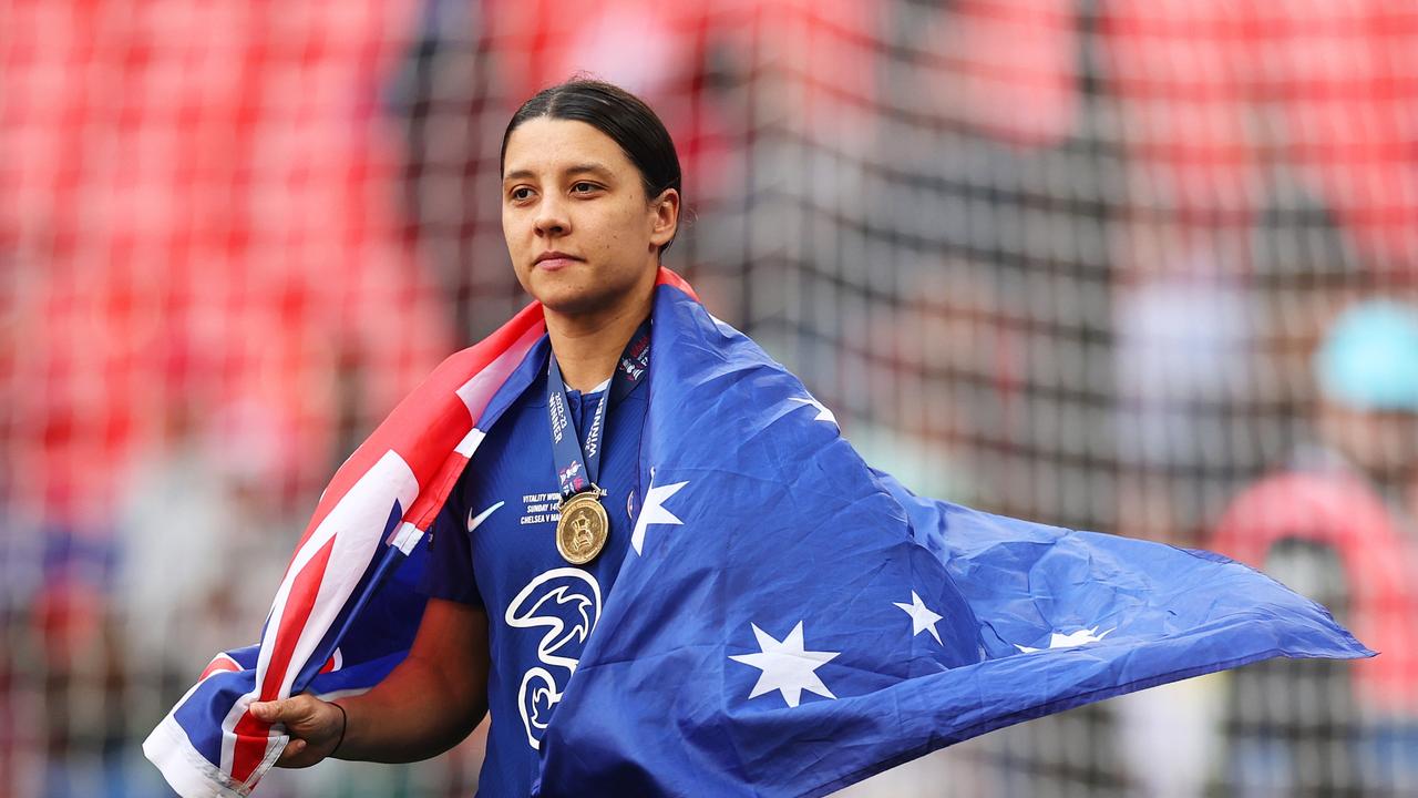 Sam Kerr wrapped in an Aussie flag. Photo by Ryan Pierse/Getty Images.