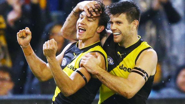 Daniel Rioli celebrates a goal with Trent Cotchin.