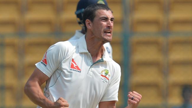 Australian bowler Mitchell Starc celebrates the dismissal of Indian batsman Karun Nair.