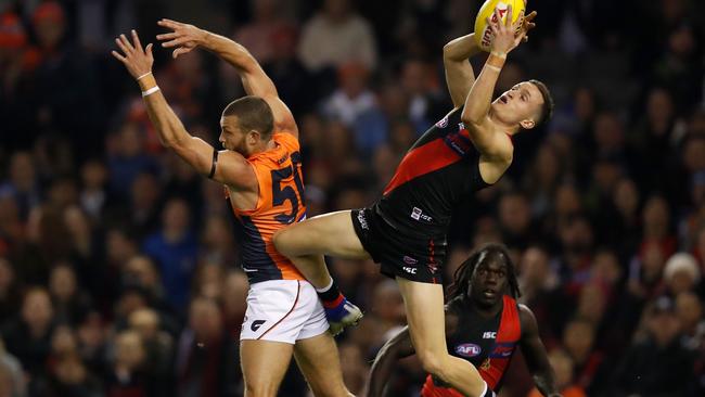 Orazio Fantasia of the Bombers takes a high mark over Sam Reid of the Giants. Picture: AFL Photos via Getty Images