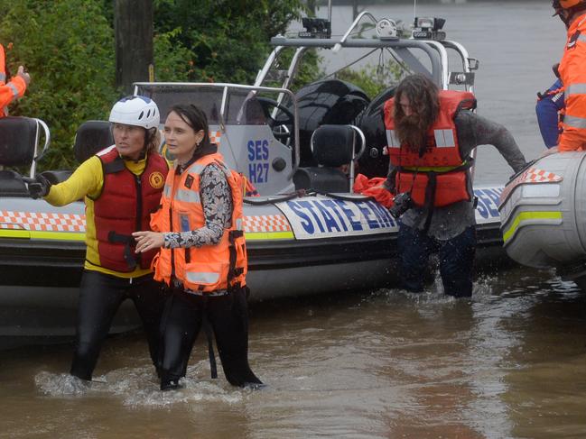 A family is rescued from floodwaters as the water levels threatened their Upper Colo home. Picture: NCA NewsWire / Jeremy Piper