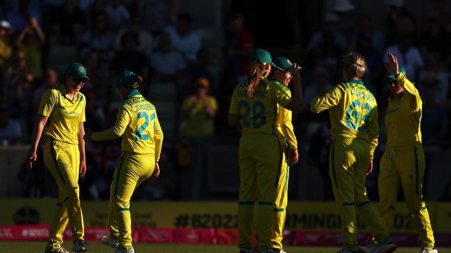 Tahlia McGrath celebrates with Jess Jonassen by tapping ankles. Picture: Ryan Pierse/Getty Images