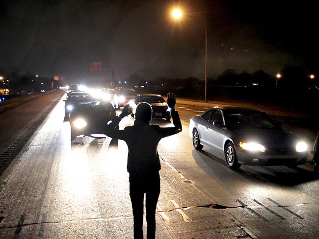 No surrender ... Protesters shut down an interstate at Airport Road in Berkeley for a second night after the shooting by a white police officer of a black 18-year-old. Source: AP