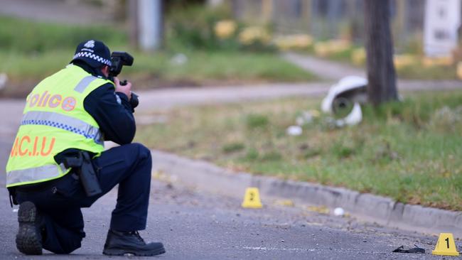 A crash investigator photographs the scene in Ballarat Rd, Ardeer. Picture: Jay Town