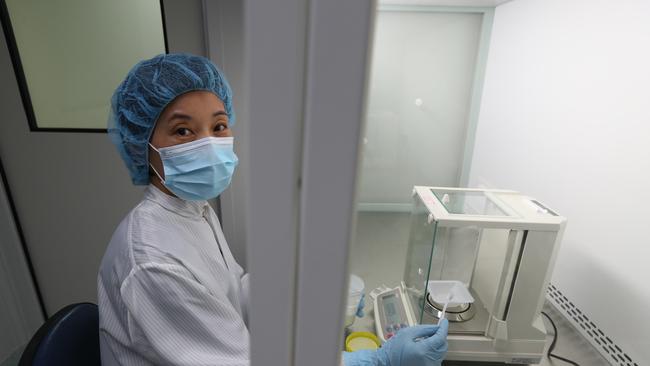 Zuhong Qiu — a production technician — weighing the raw product. Picture: Tait Schmaal